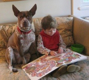 boy rading to dog